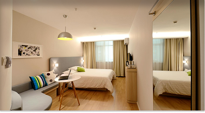 Modern hotel room with bed and furniture