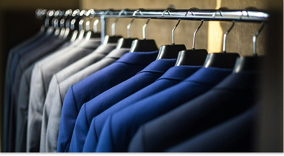 Business suits hanging on rack in retail store