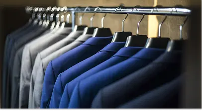 Business suits hanging on rack in retail store